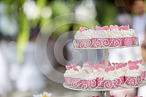 Many cupcakes on shelf shelves in wedding party. dessert serving for wedding guest. sweets mini cakes