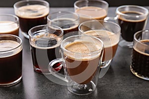 Many cups of different aromatic hot coffee