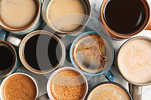 Many cups of different aromatic hot coffee on table top view