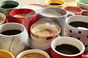 Many cups of different coffees on table, closeup