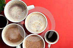 Many cups with tasty aromatic coffee on color background, flat lay