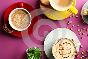 Many cups with tasty aromatic coffee on color background, flat lay