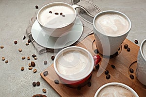 Many cups with tasty aromatic coffee on grey table
