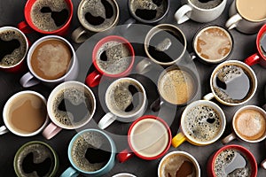 Many cups with tasty aromatic coffee on table