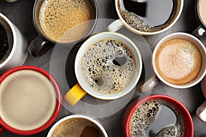 Many cups with tasty aromatic coffee on table