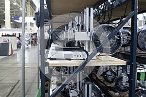 Many 3D printers printing an object. 3D printers simultaneously printing model