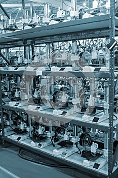 Many 3D printers printing an object. 3D printers simultaneously printing model