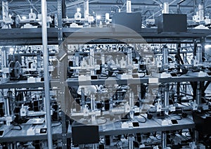 Many 3D printers printing an object. 3D printers simultaneously printing model