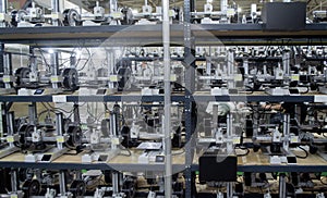 Many 3D printers printing an object. 3D printers simultaneously printing model
