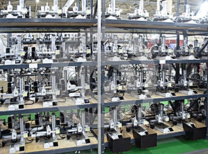 Many 3D printers printing an object. 3D printers simultaneously printing model