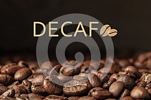 Many decaf coffee beans on dark background, closeup