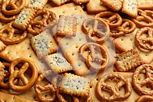 Many delicious crackers as background, closeup view
