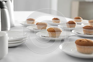 Many delicious muffins served on table for coffee break