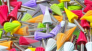 Many dental tools drills different colors close-up, dentistry concept background