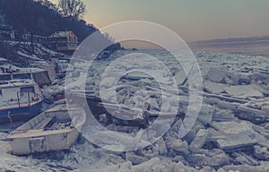 Many destroyed boats on a frozen Danube river haze effect