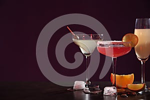 Many different alcoholic drinks on table against dark background. Space for text