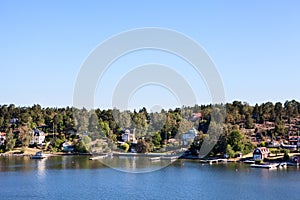 Many different building and houses are on coastline of Stockholm archipelago in Sweden. Joint valley landscape. Scandinavia