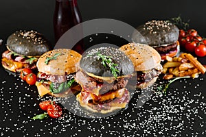 Many different burgers with ingredients on a black background