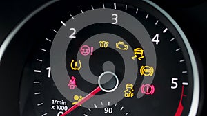 Many different car dashboard lights with warning lamps illuminated. Light symbol that pops up on dashboard when