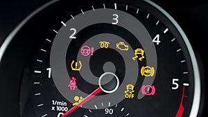 Many different car dashboard lights with warning lamps illuminated. Light symbol that pops up on dashboard when photo