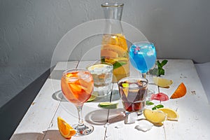Many different cocktails on a light background. Mixology and nightlife concept.