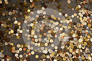 Many different coins at the ground