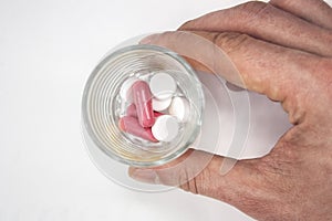 Many different colored pills isolated on white background