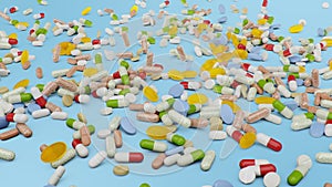 Many different colored tablets, capsules on blue background. Health care concept. Antibiotics inside pills, vitamins