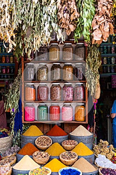 Many different colour spices in glass jars in a spices market in Marrakesh, Morocco