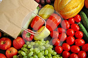 Many different fruit and vegetables and papaer bag, green glocery shop, healthy fresh colored fruits and vegetables background