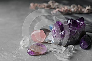 Many different gemstones on marble table photo