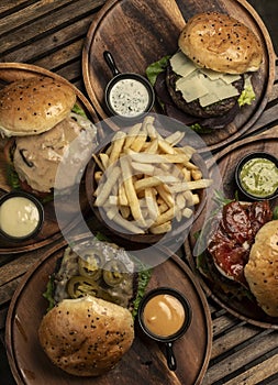 many different gourmet burgers selection on wood table