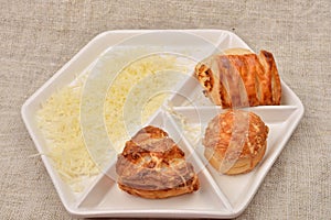 Many different kind of fresh puff pastry with cheese on a white