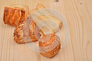 Many different kinds puff pastry with cottage cheese on wooden b