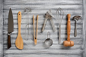 Many different kitchen utensils, wooden and metal, on a beautiful background
