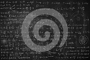 Many different physics formulas written on blackboard