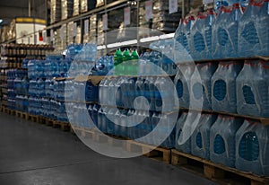 Many different plastic bottles with water at wholesale market