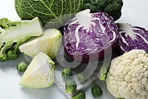 Many different types of cabbage on white table