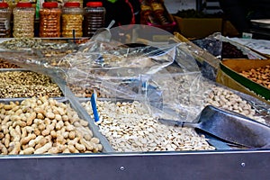 Many different types of roasted nuts and seeds for sale in the market.