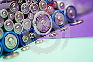 Many different types used or new battery, rechargeable accumulator, alkaline batteries on color background