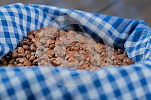 Many of dried raw brown kidney beans on a tablecloth