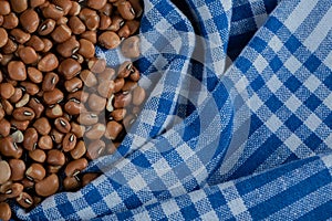 Many of dried raw brown kidney beans on a tablecloth