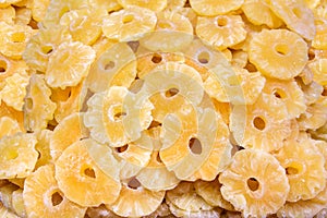 Many dried yellow pineapple slices on market