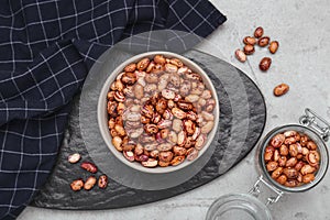 Many dry kidney beans on light grey table, flat lay