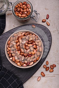 Many dry kidney beans on light grey table, flat lay