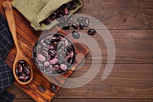 Many dry kidney beans on wooden table, flat lay. Space for text