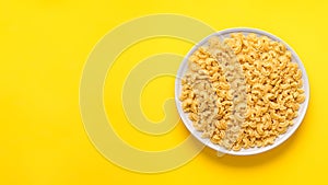 many dry unprepared pasta - cockerels on a beige plate