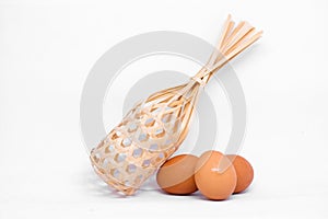 Many egg chicken with wooden basket.