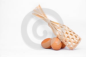 Many egg chicken with wooden basket.