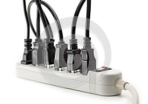 Many electrical cords connected to a power strip